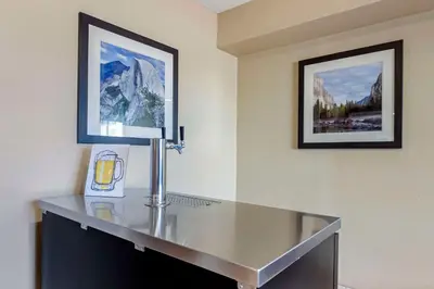 a glass table in a room with two pictures on the wall at Comfort Inn & Suites Rocklin - Roseville in Rocklin