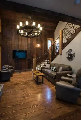 a living room with couches and a chandelier at 1R Rustic Retreat in Wawona
