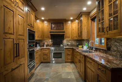 a kitchen with wooden cabinets and stainless steel appliances at 1R Rustic Retreat in Wawona