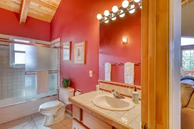 a red bathroom with a toilet and a sink at Altdorf Vista in Tyrolian Village