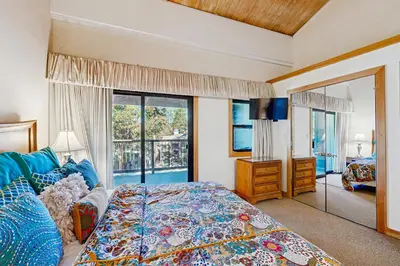 a bedroom with a bed and a large window at Brockway Springs #36 in Kings Beach