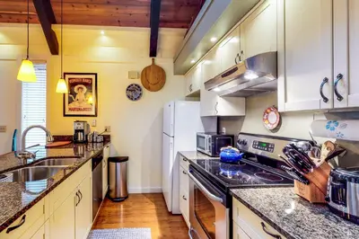 a kitchen with white cabinets and a white refrigerator at Casa del Lago in Tyrolian Village