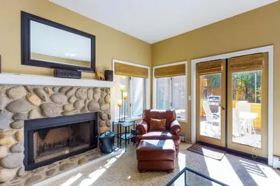 a living room with a fireplace with a flat screen tv at McCloud 137 in Incline Village