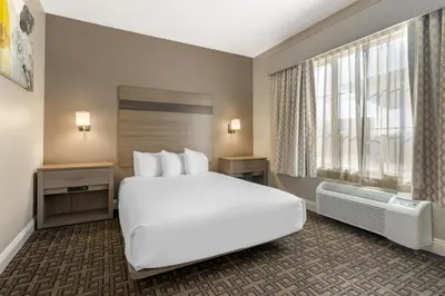 a hotel room with a large bed and a window at Best Western Kettleman City Inn & Suites in Kettleman City