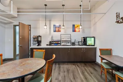 a dining room with two tables and chairs at SureStay Plus Hotel by Best Western Mammoth Lakes in Mammoth Lakes