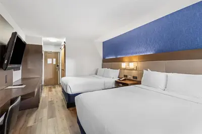a hotel room with two beds and a television at SureStay Plus Hotel by Best Western Mammoth Lakes in Mammoth Lakes