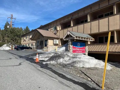 a pile of snow in front of a building at SureStay Plus Hotel by Best Western Mammoth Lakes in Mammoth Lakes