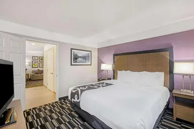 a hotel room with a bed and a flat screen tv at La Quinta by Wyndham Modesto Salida in Modesto