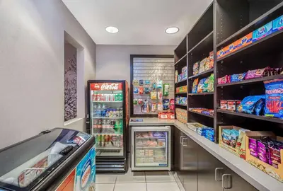 a grocery store aisle with a refrigerator and food at La Quinta by Wyndham Modesto Salida in Modesto