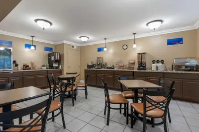 a restaurant with tables and chairs and a counter at Best Western Colonial Inn in Selma