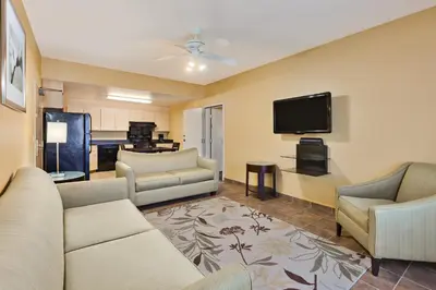 a living room with couches and a flat screen tv at Holiday Inn Express Hotel & Suites San Jose-Morgan Hill by IHG in Morgan Hill