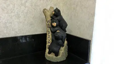 a statue of three bears sleeping on a sign at Yosemite Sierra Inn in Oakhurst