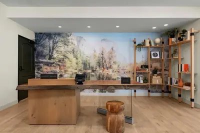a room with a large painting on the wall at The Inelle, Oakhurst Yosemite, a Tribute Portfolio Hotel in Oakhurst