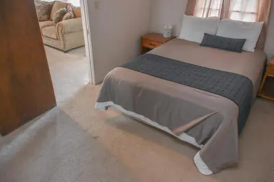 a bedroom with a bed and a couch at Panamint Springs Motel & Tents in Panamint Springs