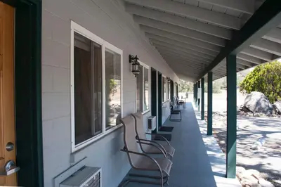 a row of benches sitting on the side of a building at Black Hawk Lodge in Coarsegold