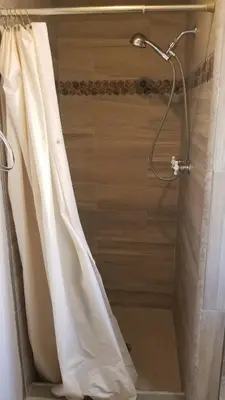 a shower with a shower curtain in a bathroom at Black Hawk Lodge in Coarsegold