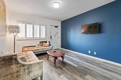 a living room with a couch and a table at Lions Gate Hotel in Sacramento