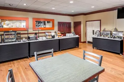 a restaurant with counters and a table in a room at Lions Gate Hotel in Sacramento