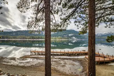 a view of a lake with a dock and trees at Donner Lake Retreat in Donner Pines Tract