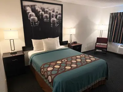 a hotel room with a bed and two lamps at Super 8 by Wyndham Selma/Fresno Area in Selma