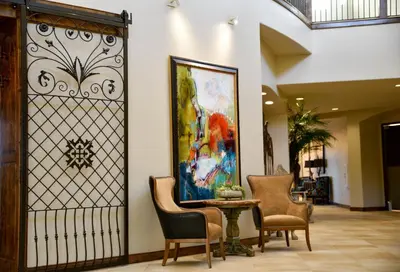 a lobby with chairs and a painting on the wall at The Murieta Inn and Spa in Rancho Murieta