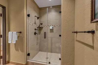 a shower with a glass door in a bathroom at The Murieta Inn and Spa in Rancho Murieta
