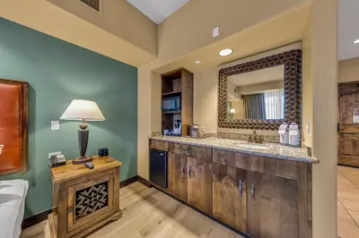a bathroom with a wooden vanity and a mirror at The Murieta Inn and Spa in Rancho Murieta