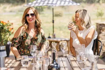 two women sitting at a table with wine glasses at The Murieta Inn and Spa in Rancho Murieta