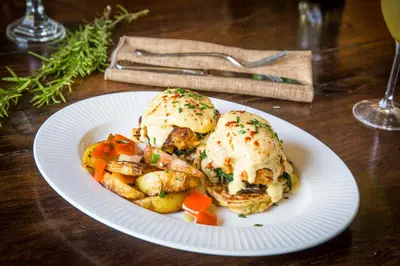 a plate with two biscuits and vegetables on a table at The Murieta Inn and Spa in Rancho Murieta
