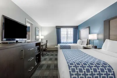 a hotel room with two beds and a flat screen tv at Cielo Hotel Bishop-Mammoth, an Ascend Collection Hotel in Bishop