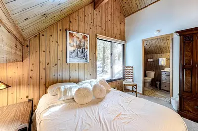 a bedroom with a bed in a wooden wall at Picture Perfect Chalet in Prosser Lakeview Estates