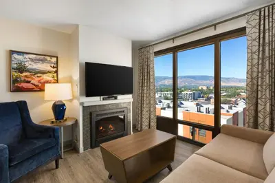 a living room with a fireplace and a large window at WorldMark Reno in Reno