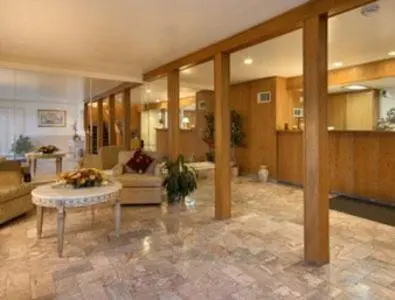 a large living room with a couch and a table at Merced Inn & Suites in Merced