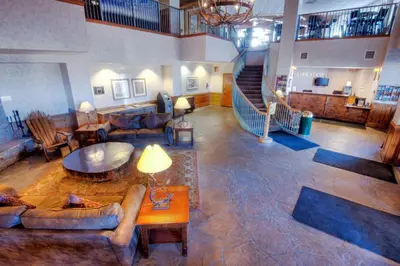 a living room with couches and a spiral staircase at Kirkwood Mountain Resort by Vail Resorts in Kirkwood