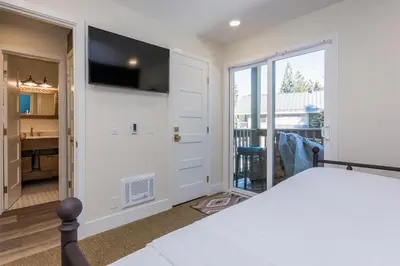 a bedroom with a bed and a sliding glass door at Crestview 35 in Mammoth Lakes
