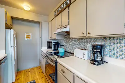 a kitchen with white cabinets and a counter top at Beauty by Kings Beach in Wood Vista
