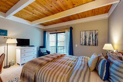 a bedroom with a large bed with a wooden ceiling at Beauty by Kings Beach in Wood Vista