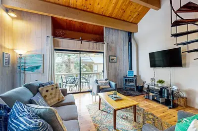 a living room with a couch and a tv at Beauty by Kings Beach in Wood Vista