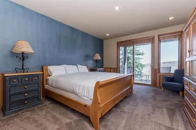a bedroom with a bed and a blue wall at Snowcreek V 820 in Mammoth Lakes
