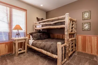 a bedroom with a log bunk bed in a room at Snowcreek V 820 in Mammoth Lakes