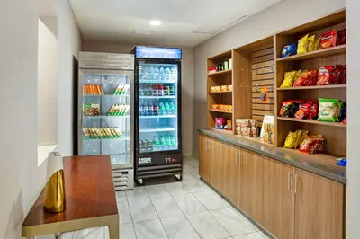 a kitchen with an open refrigerator with food inside at Best Western Plus Coalinga Inn in Coalinga