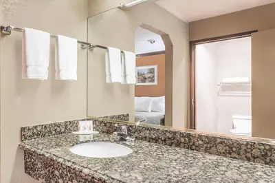 a bathroom with a sink and a mirror at Days Inn by Wyndham Bishop in Bishop