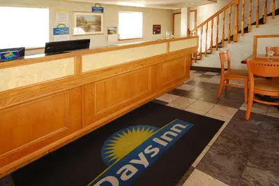 a bar in a restaurant with a table and chairs at Days Inn by Wyndham Bishop in Bishop