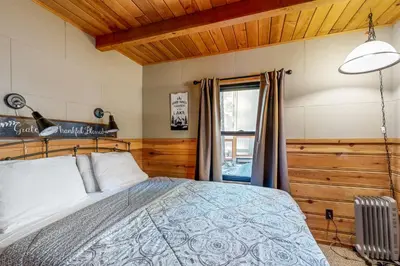 a bedroom with a bed and a window at Donner Lake Dream Cabin in Donner Lake Village
