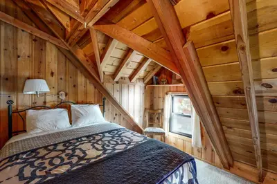 a bedroom with a bed in a wooden cabin at Donner Lake Dream Cabin in Donner Lake Village