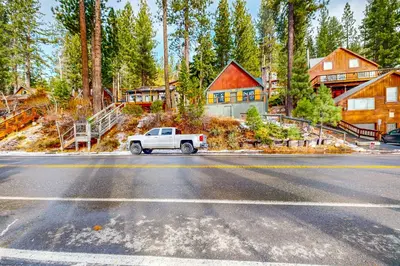 a white truck parked on a road in front of a house at Donner Lake Dream Cabin in Donner Lake Village
