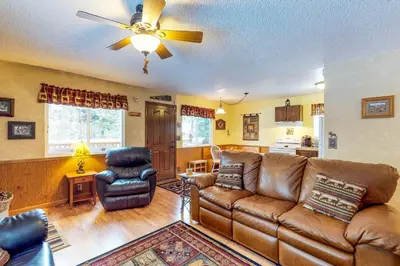 a living room with a couch and a ceiling fan at Saxon Creek in Mevers