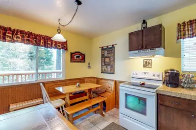 a kitchen with a table and a stove top oven at Saxon Creek in Mevers