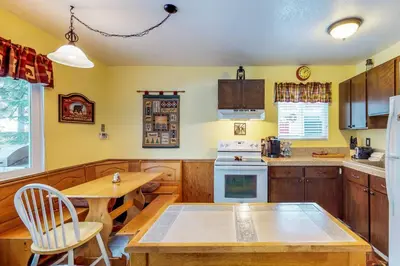 a kitchen with wooden cabinets and a wooden table at Saxon Creek in Mevers