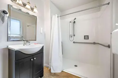 a white bathroom with a sink and a shower at Econo Lodge Inn & Suites Heavenly Village Area in South Lake Tahoe